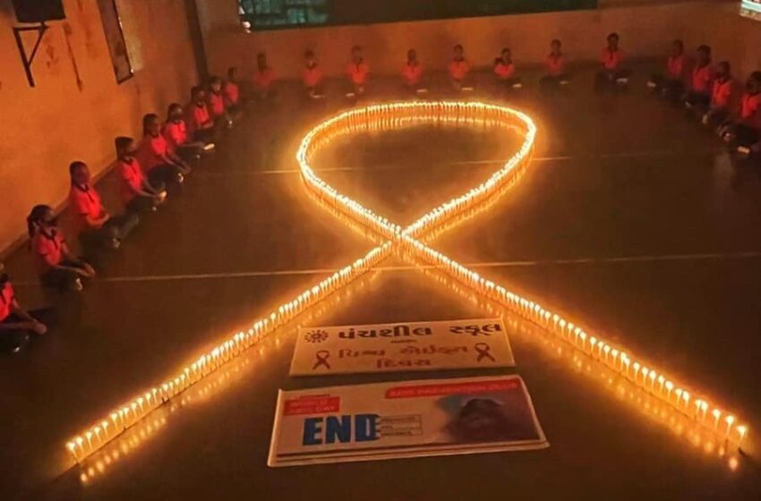  YOUNGEST STUDENTS CELEBRATED WORLD AIDS DAY WITH 500 CANDLES IN AIDS RIBBON SHAPE