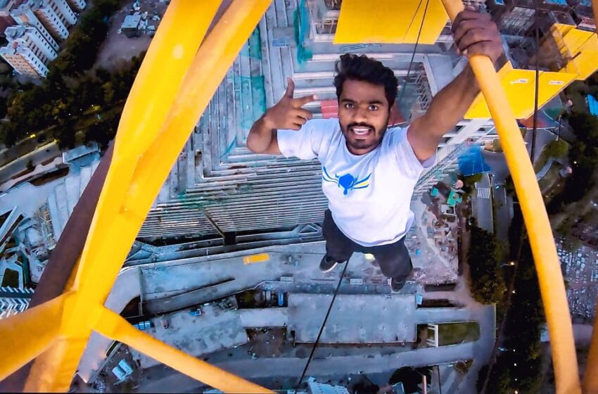  FIRST-PERSON TO HANG WITH ONE HAND ON BUILDING CRANE AT MAXIMUM HEIGHT