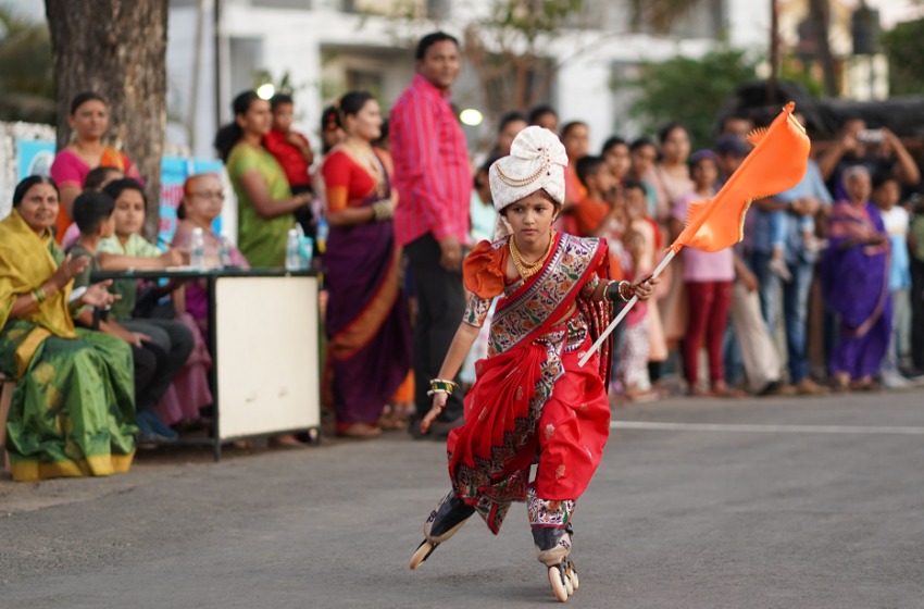  YOUNGEST GIRL TO PERFORM INLINE SKATING IN TRADITIONAL ATTIRE BY HOLDING A FLAG.
